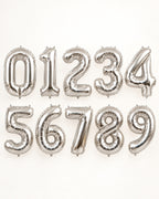 Silver foil number balloons from 0 to 9, arranged in two rows