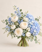 Blue Cloud bouquet with blue hydrangea, white peonies, blue delphinium, and eucalyptus