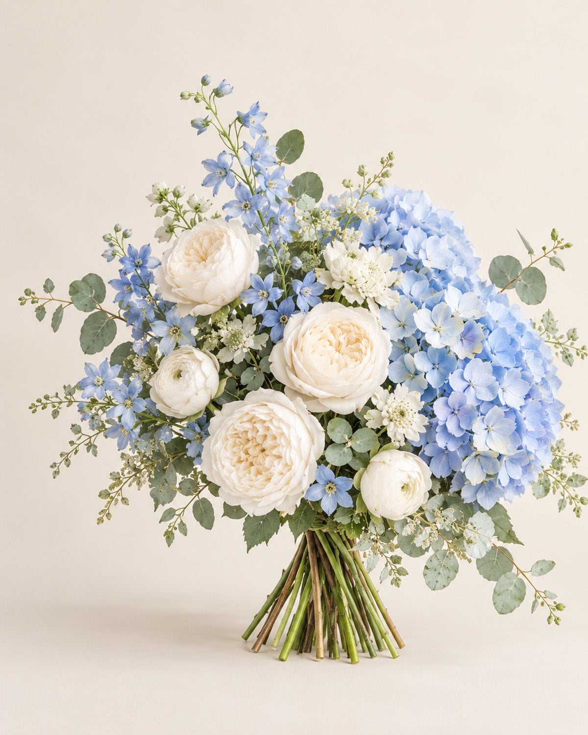 Blue Cloud bouquet with blue hydrangea, white peonies, blue delphinium, and eucalyptus