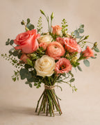 Coral and cream hand-tied bouquet with roses and greenery