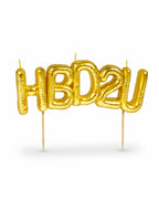 Gold balloon-style letter candles spelling "HBD2U"