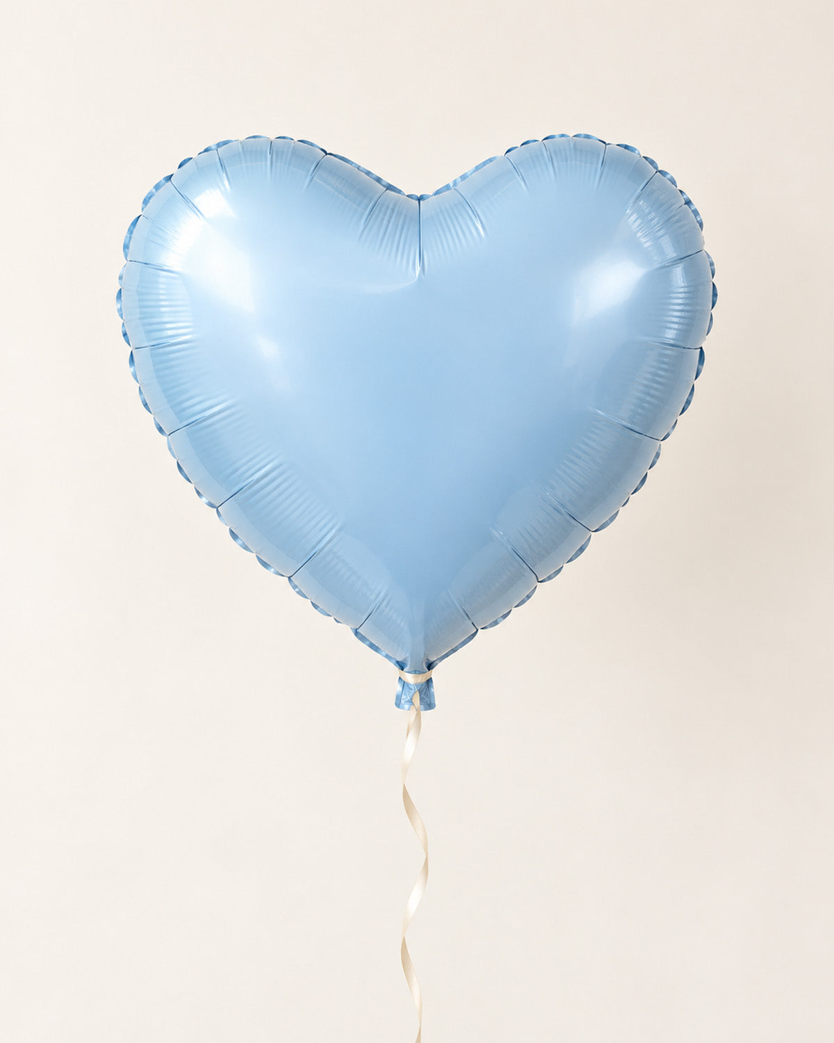 Baby blue heart-shaped foil balloon with a thin ribbon