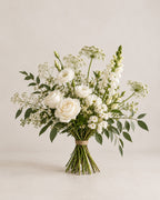 White rose bouquet with lisianthus, snapdragons, delicate white flowers and greenery